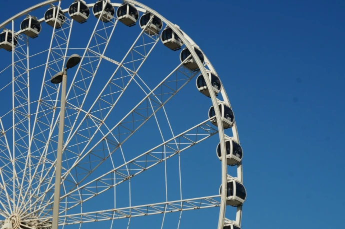 white and black ferris wheel under blue sky during daytime